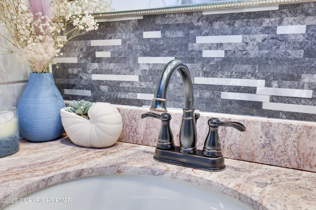 an aerial view of a house with a yard and large trees