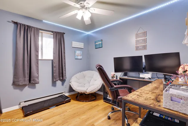 a room with pool table and chairs