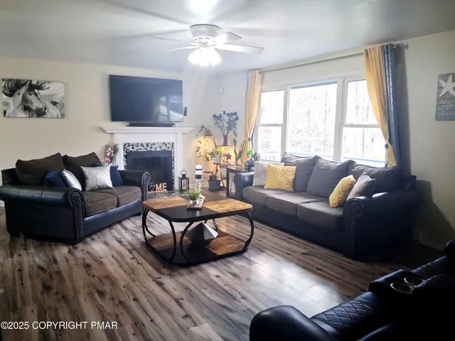 a living room with furniture fireplace and a flat screen tv