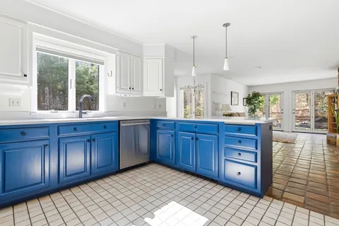a view of kitchen with granite countertop cabinets and wooden floor