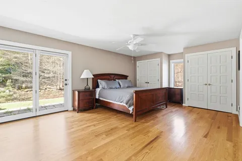 a bedroom with a bed and large window