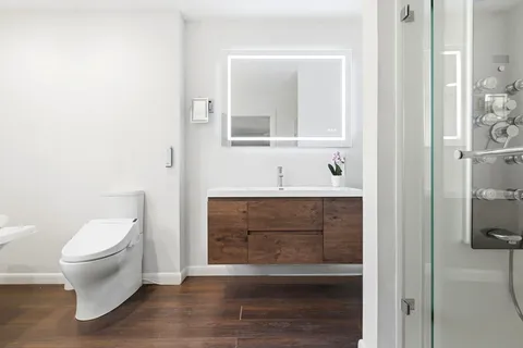 a bathroom with a toilet sink and shower