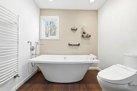 a white bath tub sitting next to a white toilet