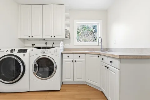 a utility room with sink dryer and washer