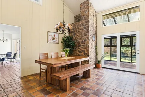 a view of a room with a table and chairs