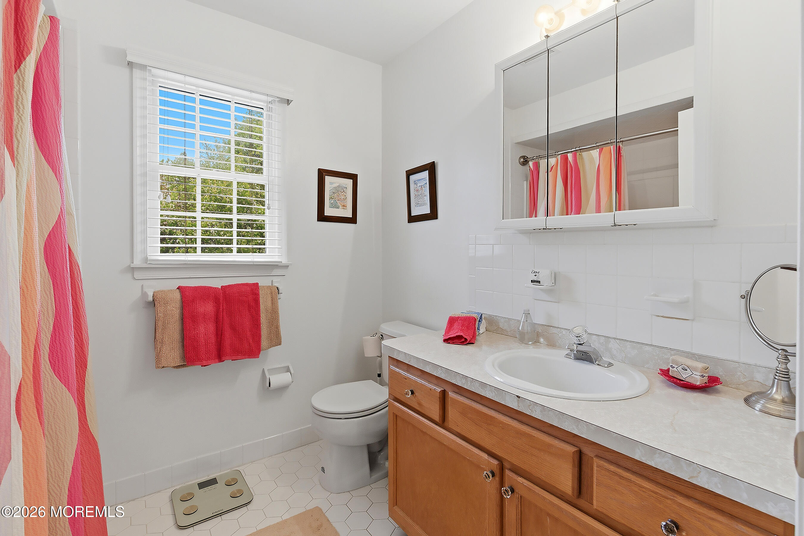 924 Ocean Road Point Pleasant, NJ 08742 - Photo 31 of 56 a bathroom with a sink toilet vanity and window
