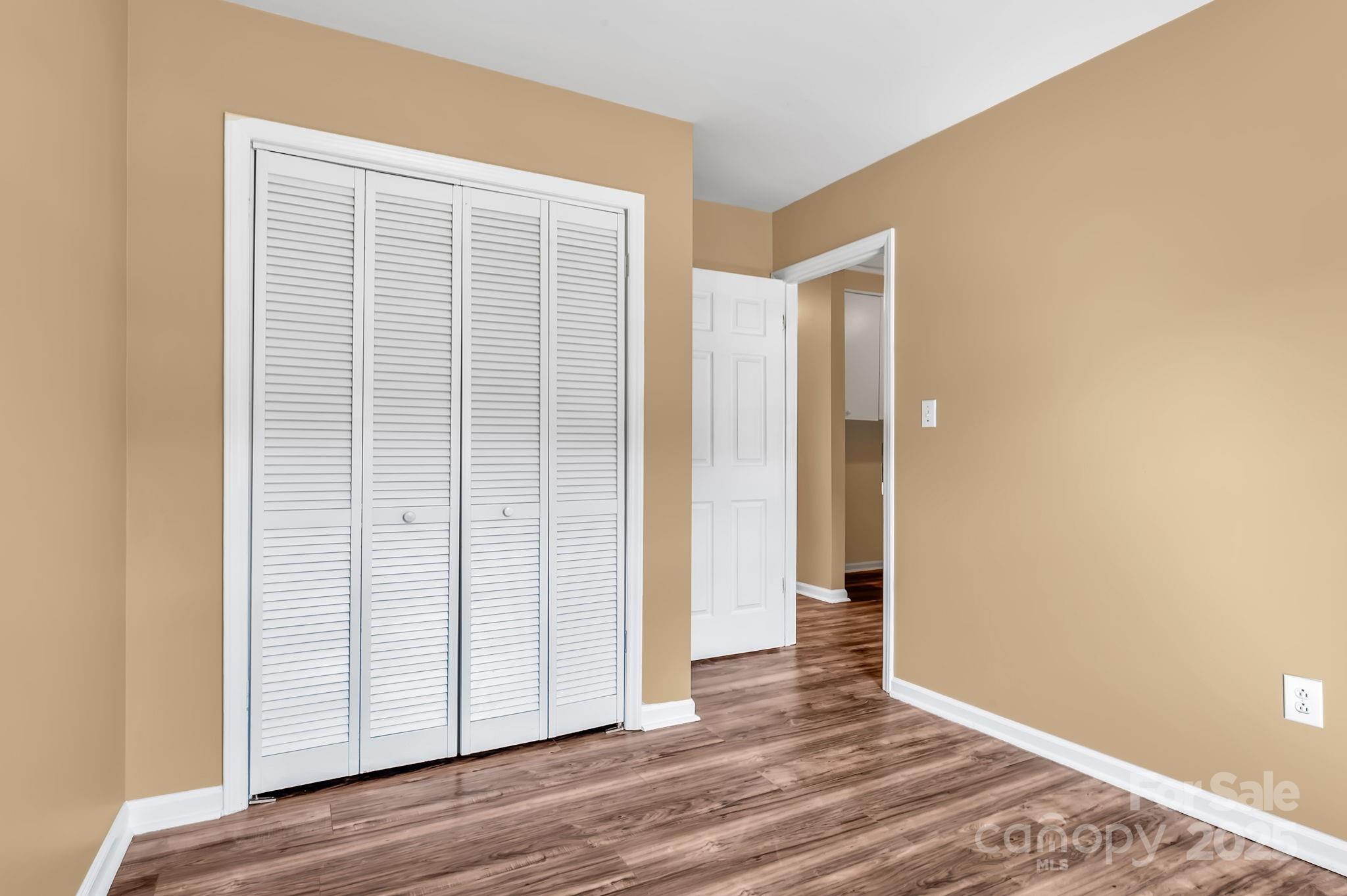88 Lees Creek Road Asheville, NC 28806 - Photo 14 of 17 an empty room with wooden floor and closet