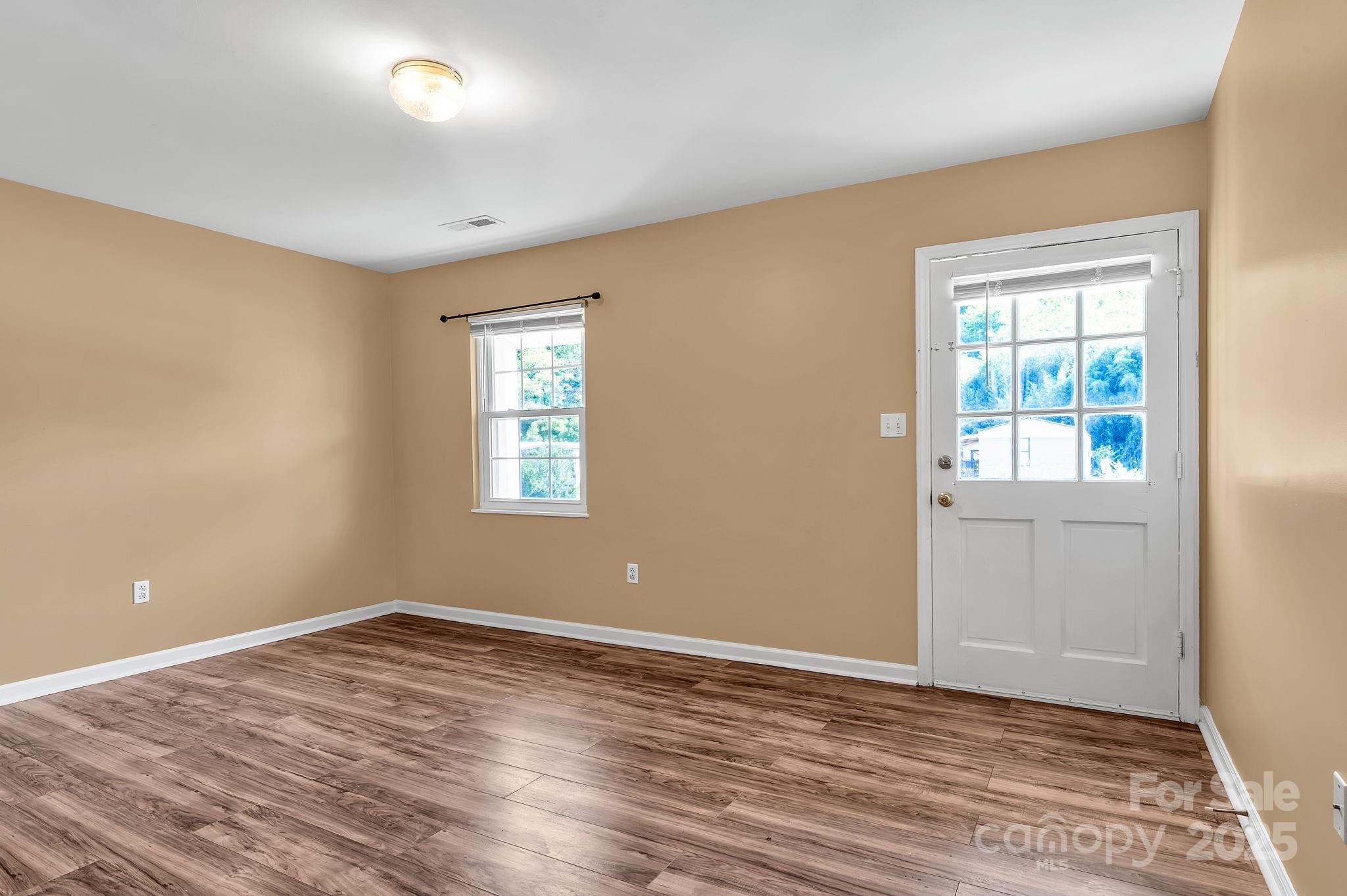 88 Lees Creek Road Asheville, NC 28806 - Photo 3 of 17 a view of empty room with wooden floor and fan