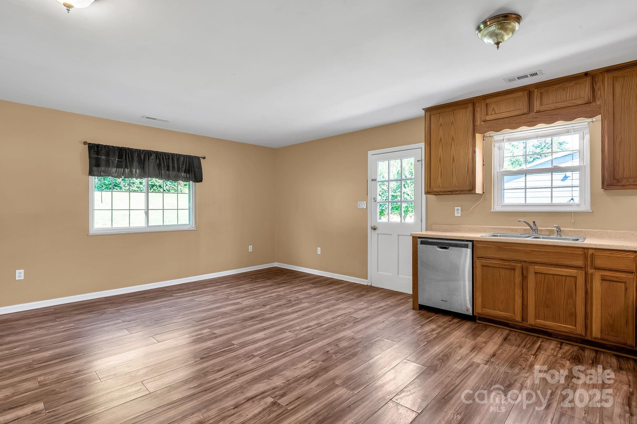 88 Lees Creek Road Asheville, NC 28806 - Photo 5 of 17 a view of a kitchen with a sink dishwasher and a wooden floor