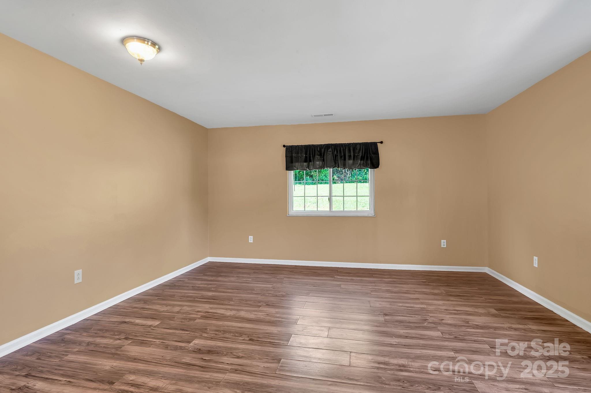 88 Lees Creek Road Asheville, NC 28806 - Photo 6 of 17 wooden floor in an empty room with a window