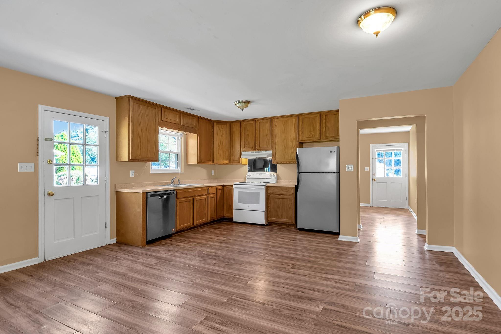 88 Lees Creek Road Asheville, NC 28806 - Photo 7 of 17 a kitchen with stainless steel appliances a refrigerator sink and cabinets