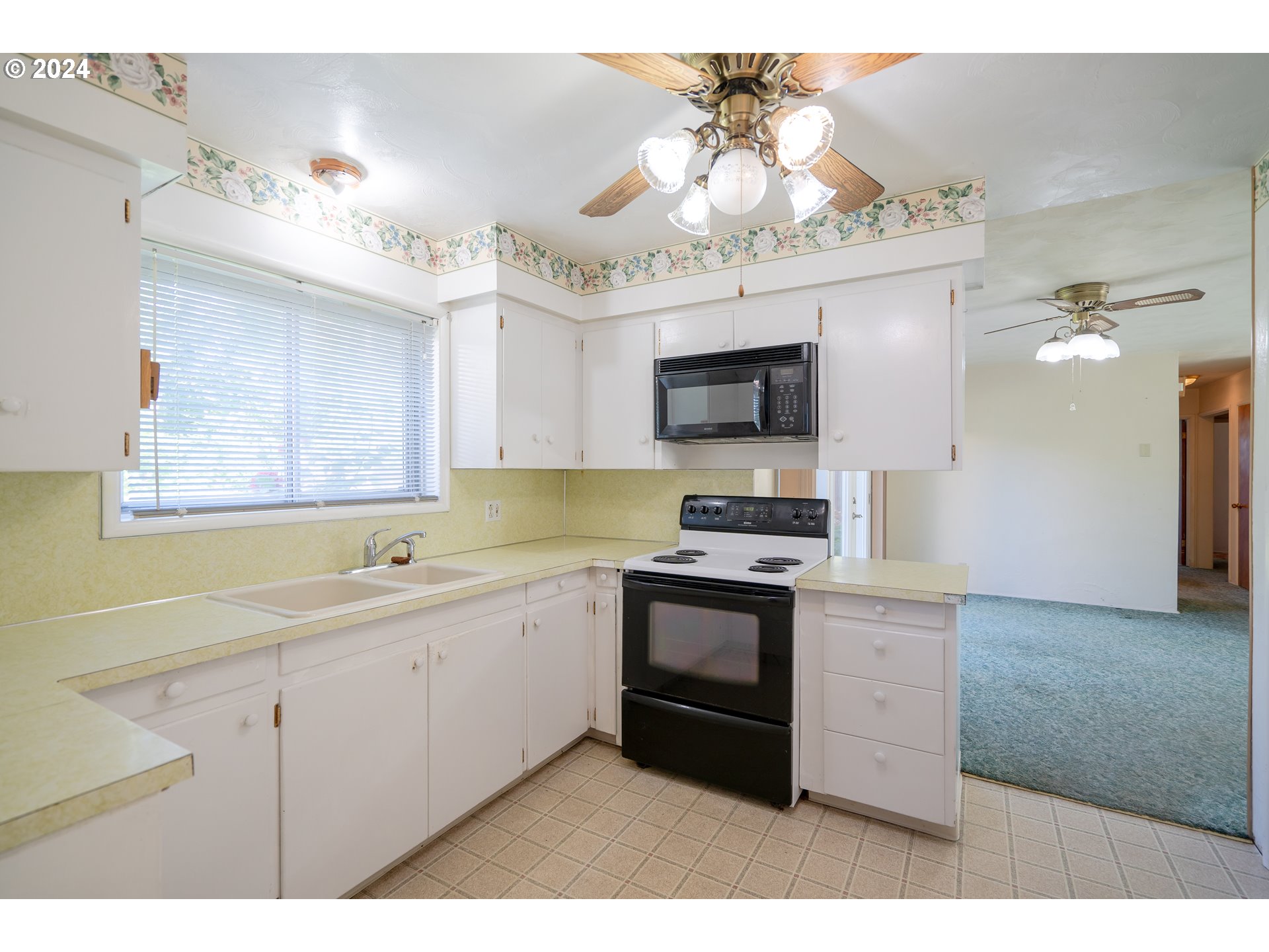 944 Filbert Lane Springfield, OR 97478 - Photo 8 of 24 a kitchen with a sink stainless steel appliances cabinets and a chandelier