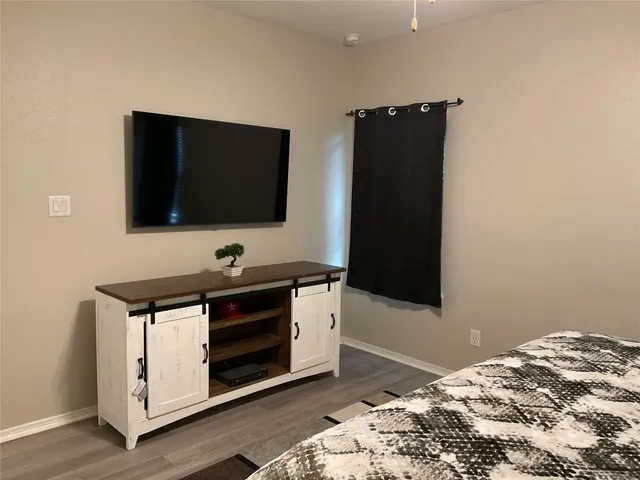 a view of bedroom with a flat screen tv and a bed