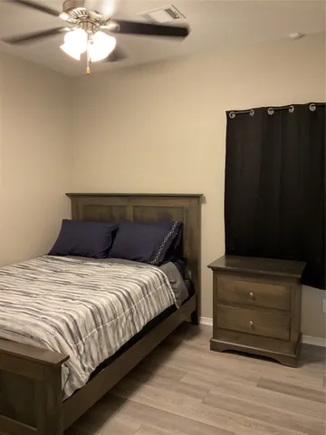 a bedroom with a bed and a mirror