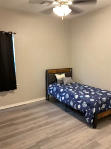 a bedroom with a bed and a mirror