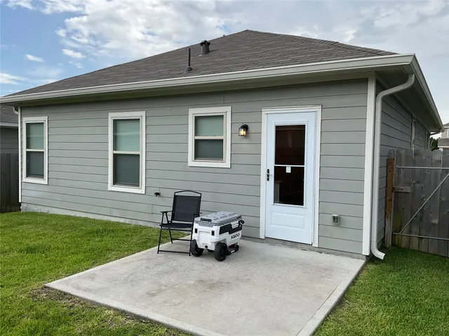 a backyard of a house with table and chairs