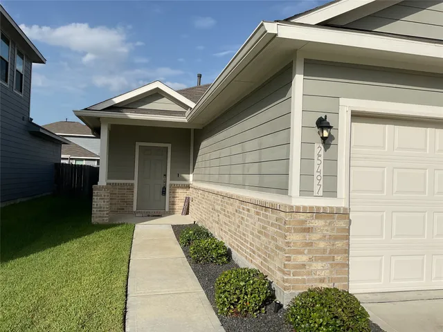 a front view of a house with a garden