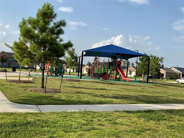 a view of a park with swings and slides