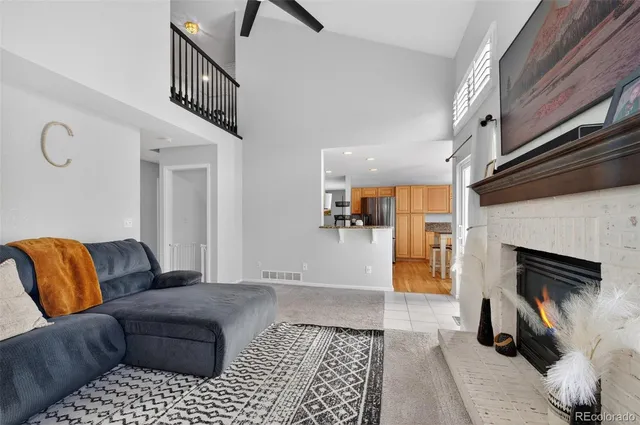 a view of a hallway to a livingroom with furniture