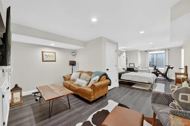 a bedroom with furniture and wooden floor