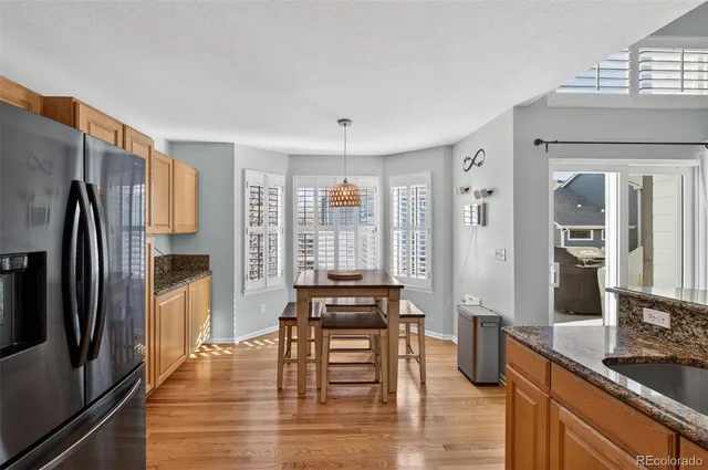 a kitchen with stainless steel appliances granite countertop a stove a sink dishwasher a refrigerator and a oven