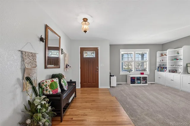 a view of a livingroom with a furniture wooden floor and windows