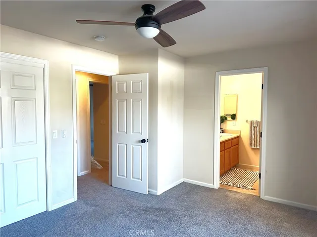 a view of an empty room and a bathroom