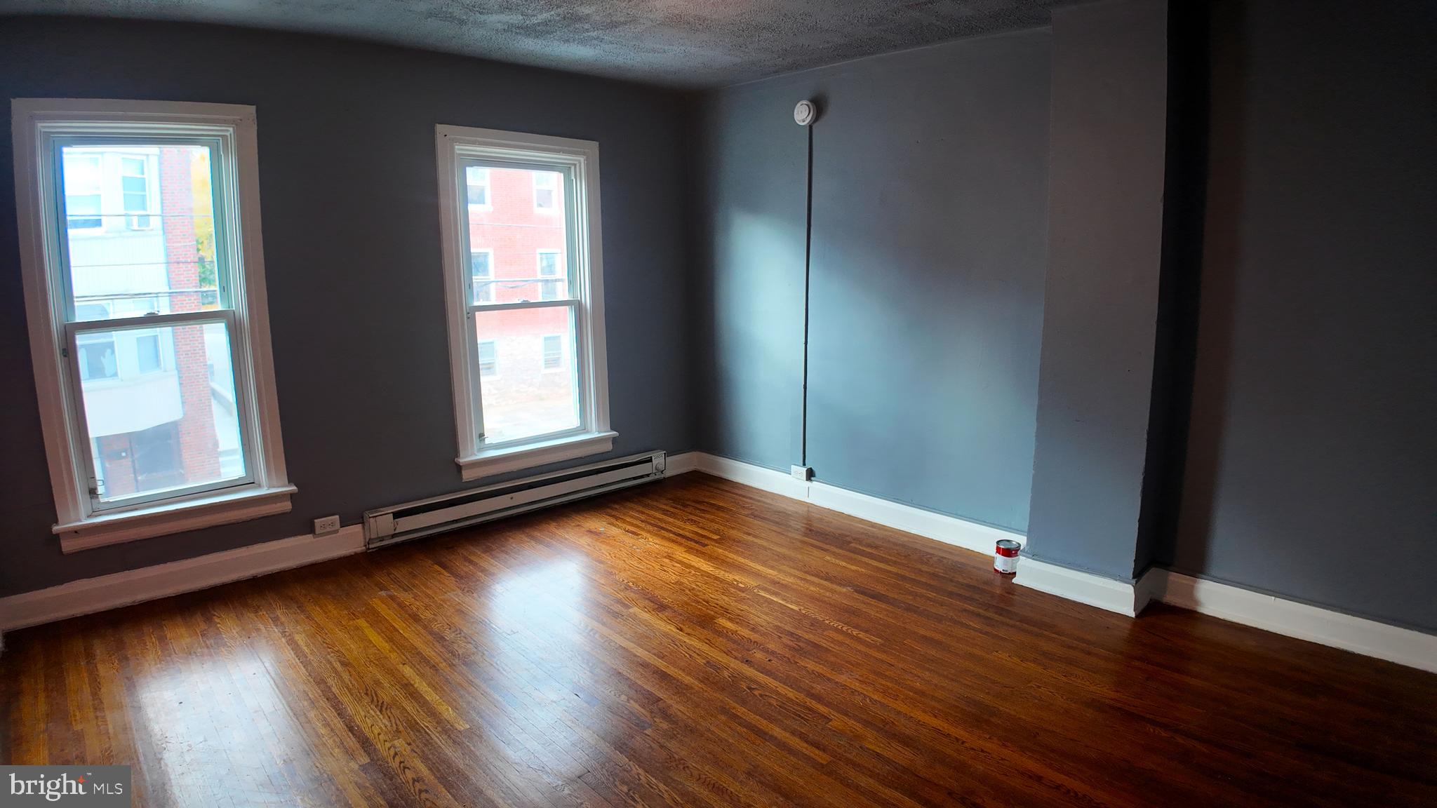 228 North Locust Street, Unit 4 Hagerstown, MD 21740 - Photo 11 of 16 an empty room with wooden floor and windows