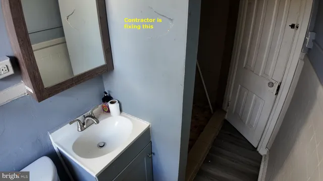 a bathroom with a sink and mirror