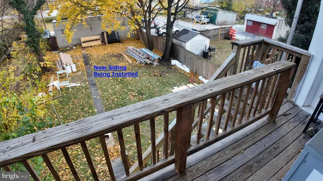 a view of balcony with wooden floor and outdoor seating