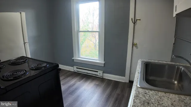 a kitchen with a stove a microwave and a window