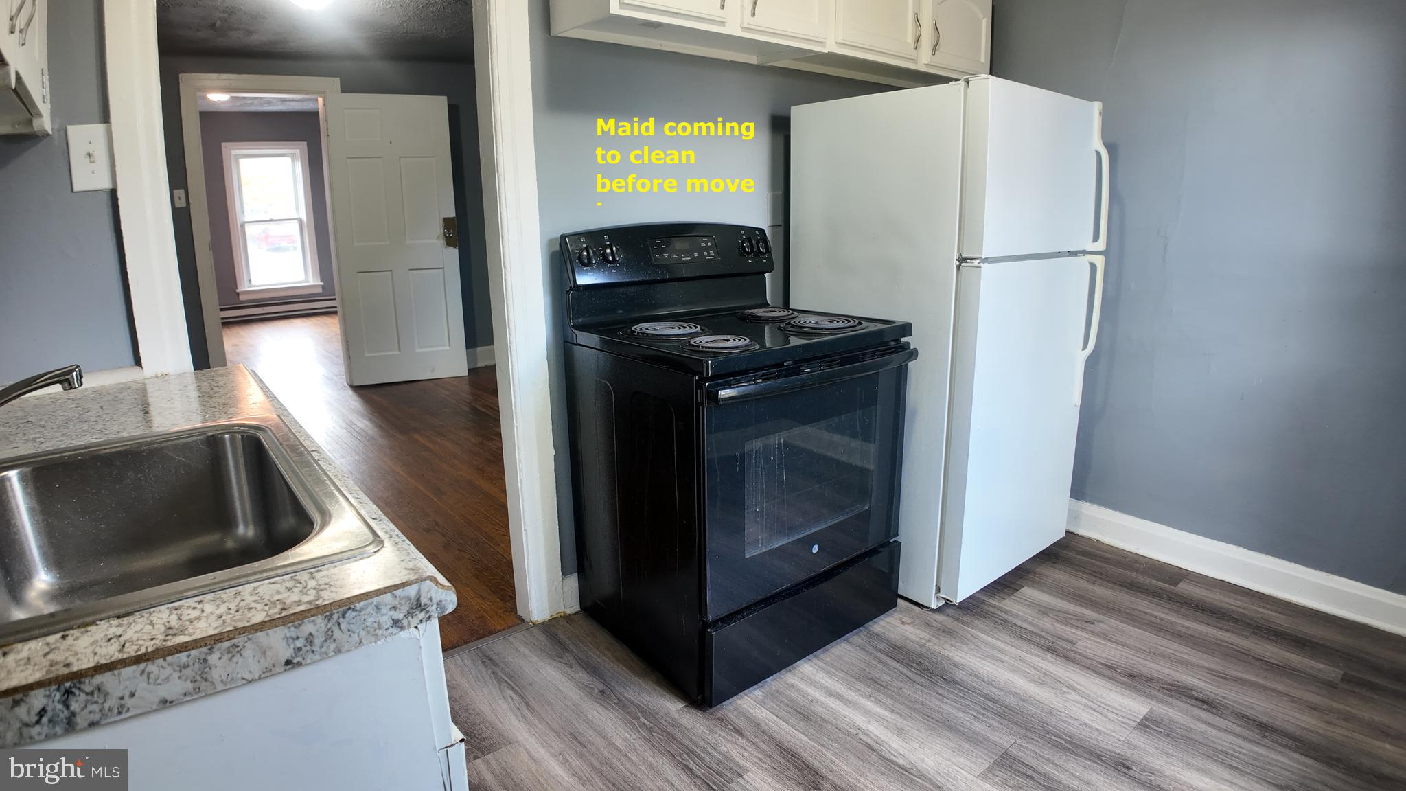 228 North Locust Street, Unit 4 Hagerstown, MD 21740 - Photo 3 of 16 a kitchen with a stove and a microwave