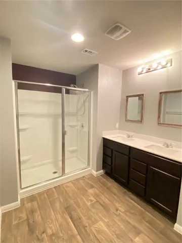 a bathroom with a double vanity sink and a mirror