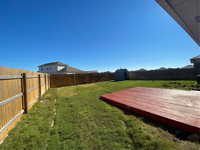a view of a wooden deck with a yard