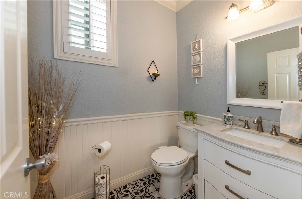 40232 Pasadena Drive Temecula, CA 92591 - Photo 21 of 44 a bathroom with a granite countertop toilet sink and mirror