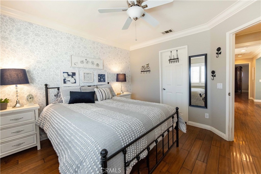 40232 Pasadena Drive Temecula, CA 92591 - Photo 32 of 44 a bedroom with a bed and wooden floor