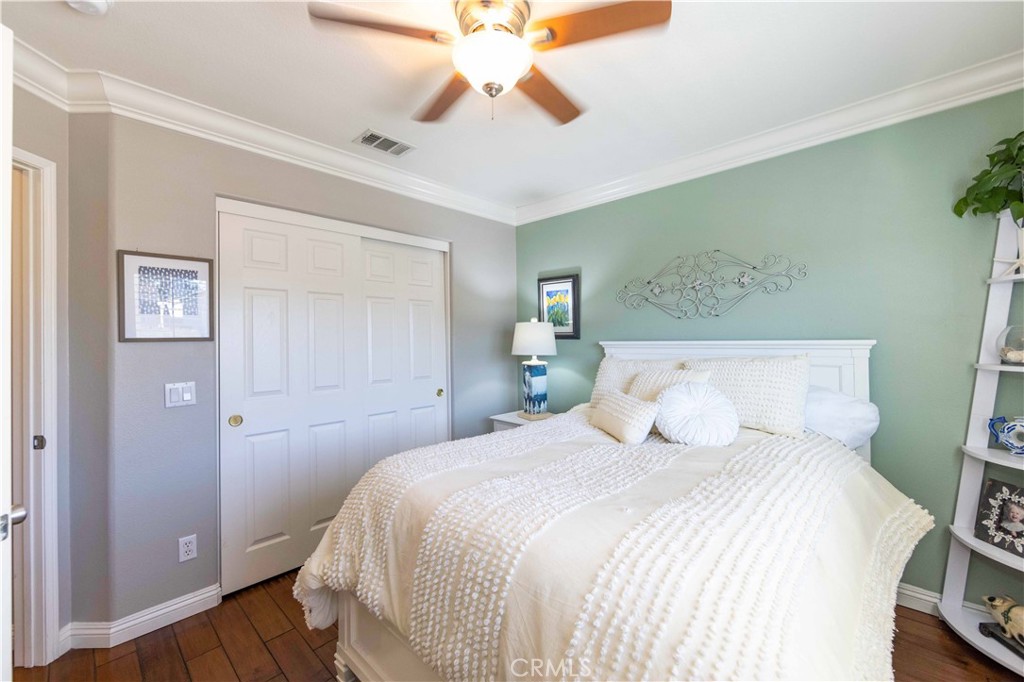 40232 Pasadena Drive Temecula, CA 92591 - Photo 35 of 44 a bedroom with a bed and a chandelier