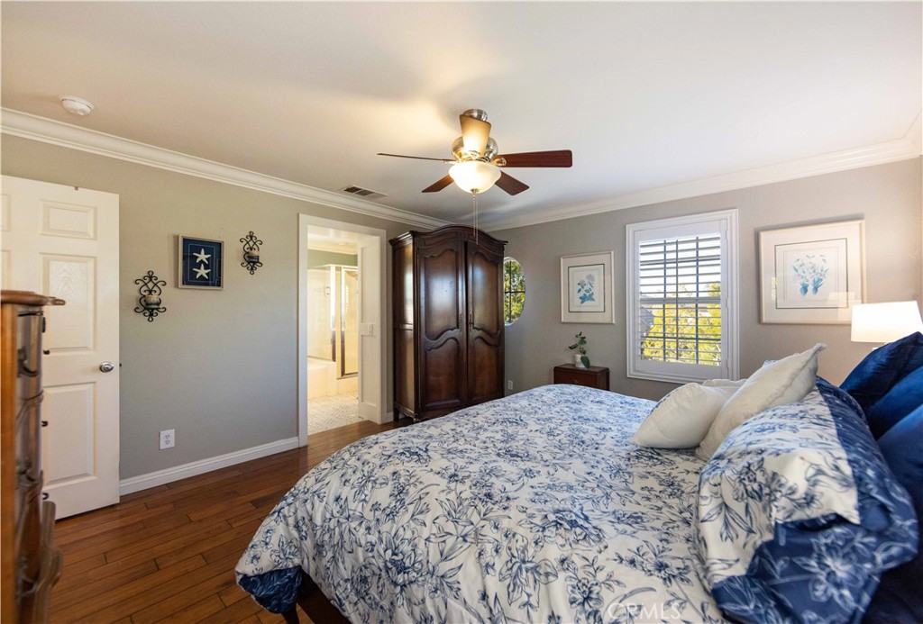 40232 Pasadena Drive Temecula, CA 92591 - Photo 38 of 44 a bedroom with a large bed and wooden floor