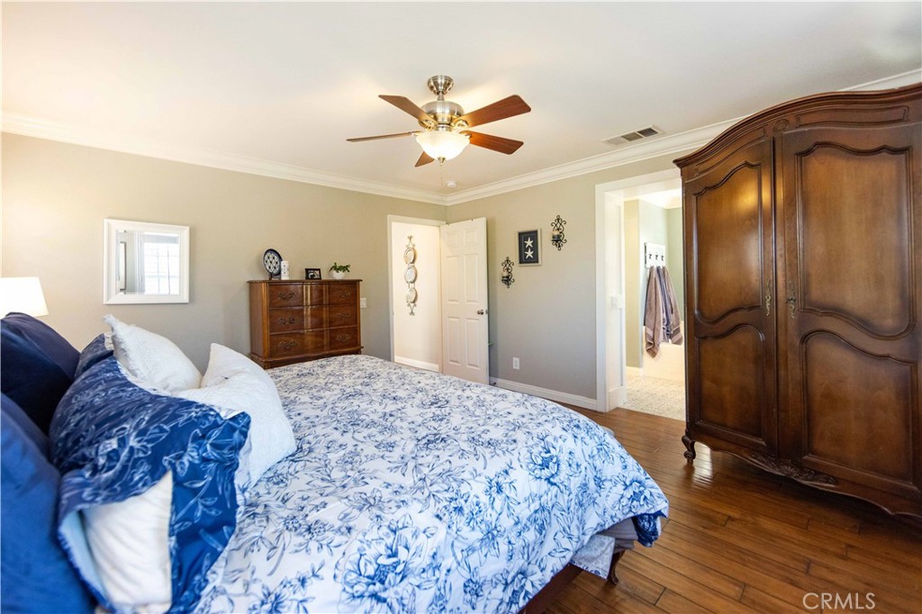 40232 Pasadena Drive Temecula, CA 92591 - Photo 39 of 44 a spacious bedroom with a bed and a dresser