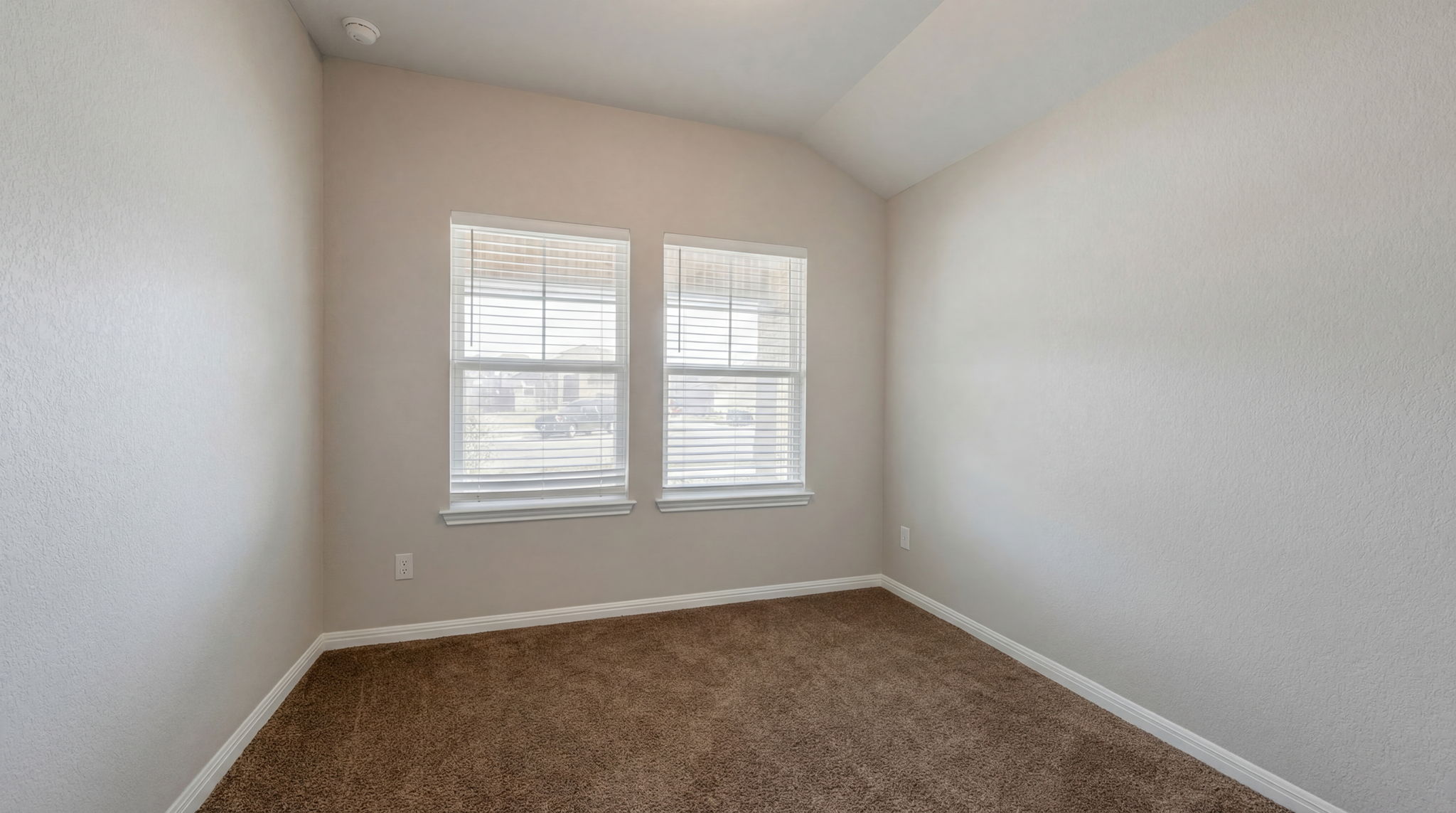 1003 Round Bale Road Hutto, TX 78634 - Photo 15 of 29 Empty room featuring dark colored carpet and lofted ceiling