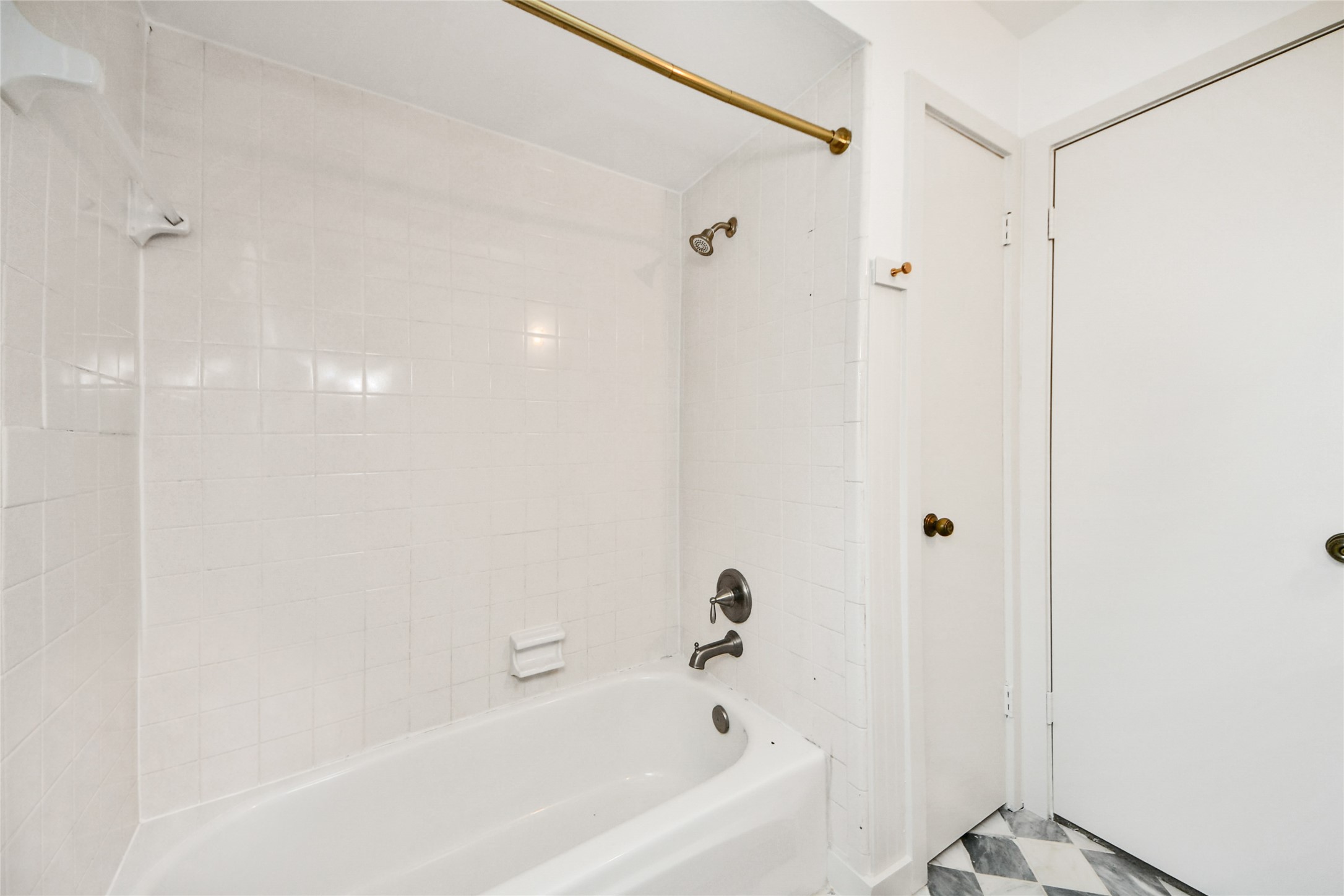 3030 Bernadette Lane Houston, TX 77043 - Photo 20 of 31 a bathroom with a bathtub and shower