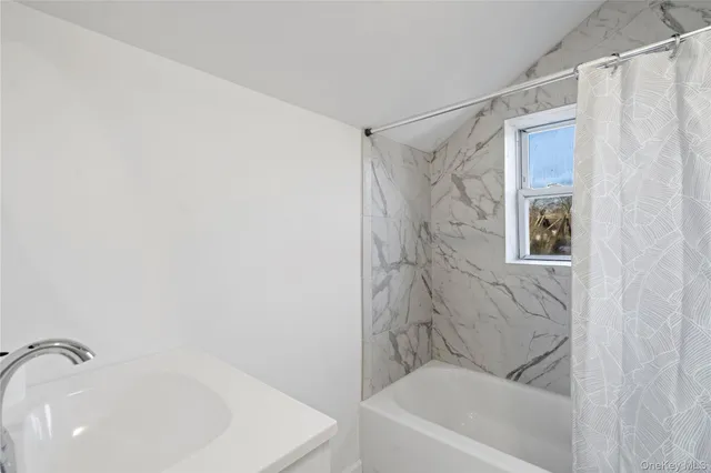 a bathroom with a bathtub and a shower