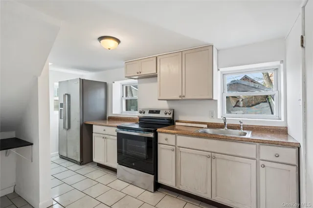 a kitchen with a sink cabinets and stainless steel appliances