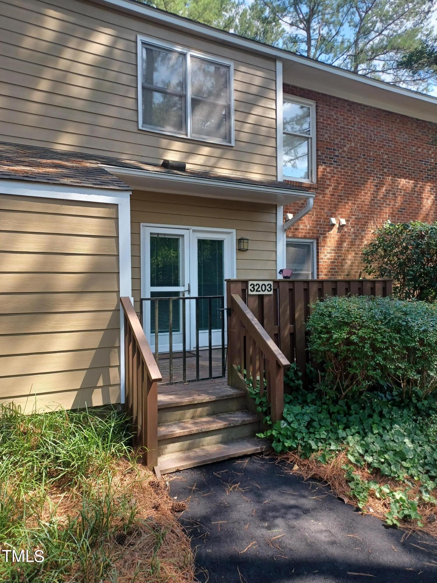 3203 Mill Run, Unit 168 Raleigh, NC 27612 - Photo 2 of 56 a view of a house with a small yard and wooden floor and fence