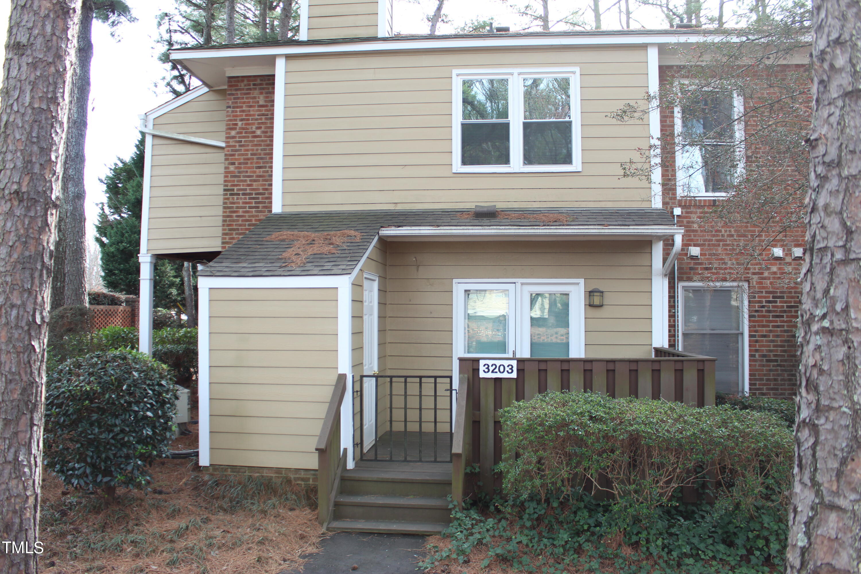 3203 Mill Run, Unit 168 Raleigh, NC 27612 - Photo 3 of 56 a front view of a house with a garden