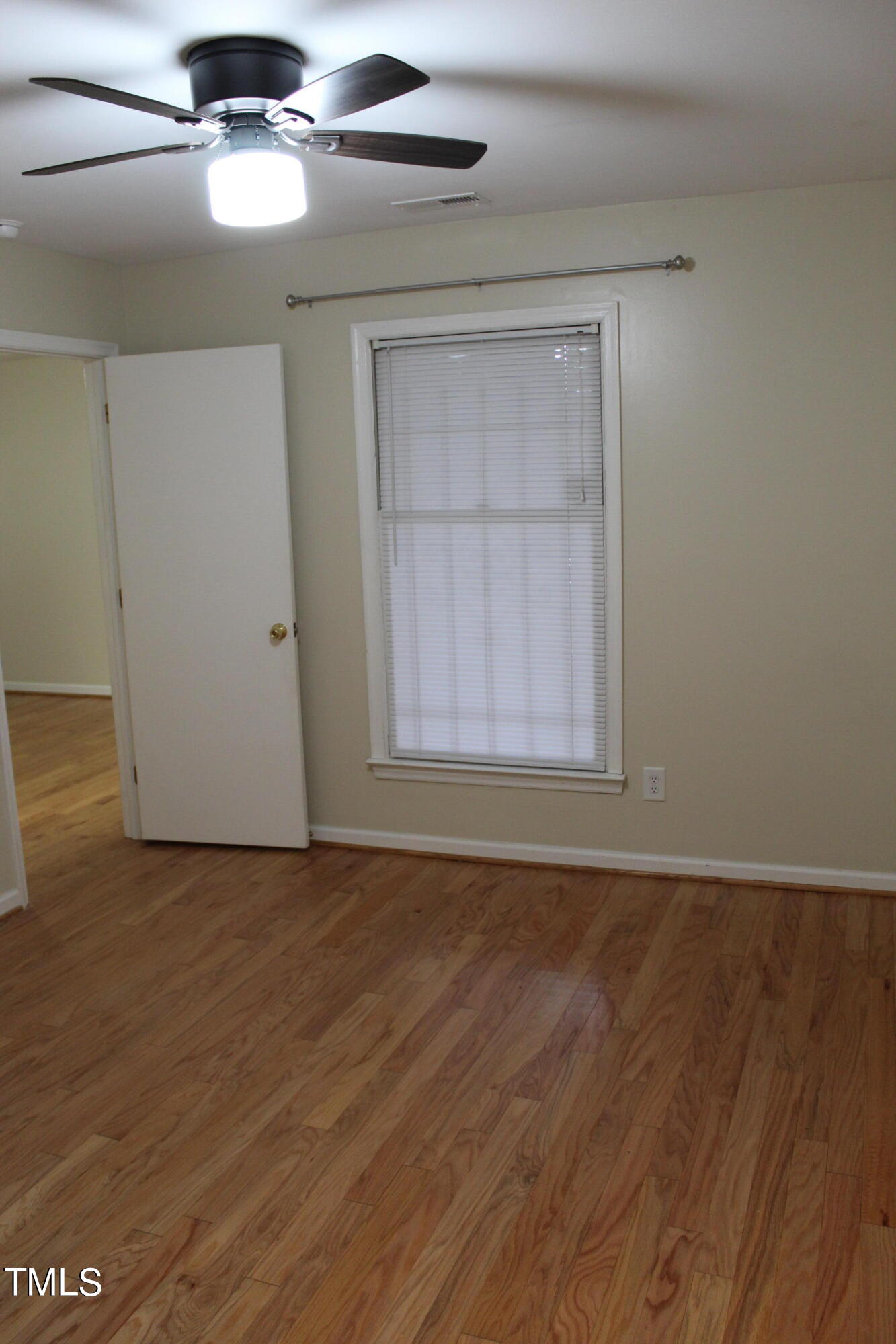3203 Mill Run, Unit 168 Raleigh, NC 27612 - Photo 43 of 56 a view of an empty room with wooden floor and a window