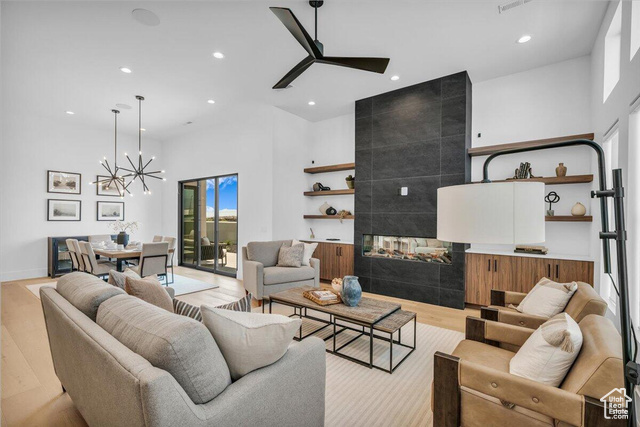 2761 West Lava Hls Road Santa Clara, UT 84765 - Photo 3 of 53 Living room featuring a fireplace, recessed lighting, ceiling fan, light wood-type flooring, and a high ceiling