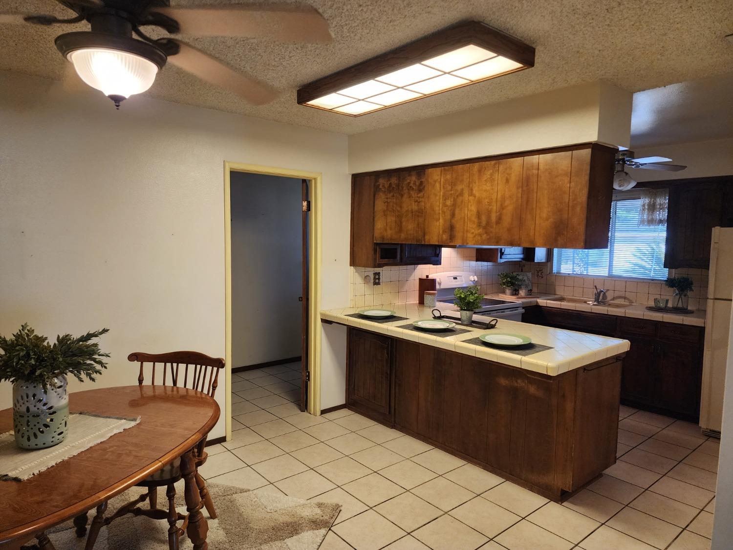 3653 Wright Street Selma, CA 93662 - Photo 20 of 41 a kitchen with stainless steel appliances granite countertop a sink stove and refrigerator