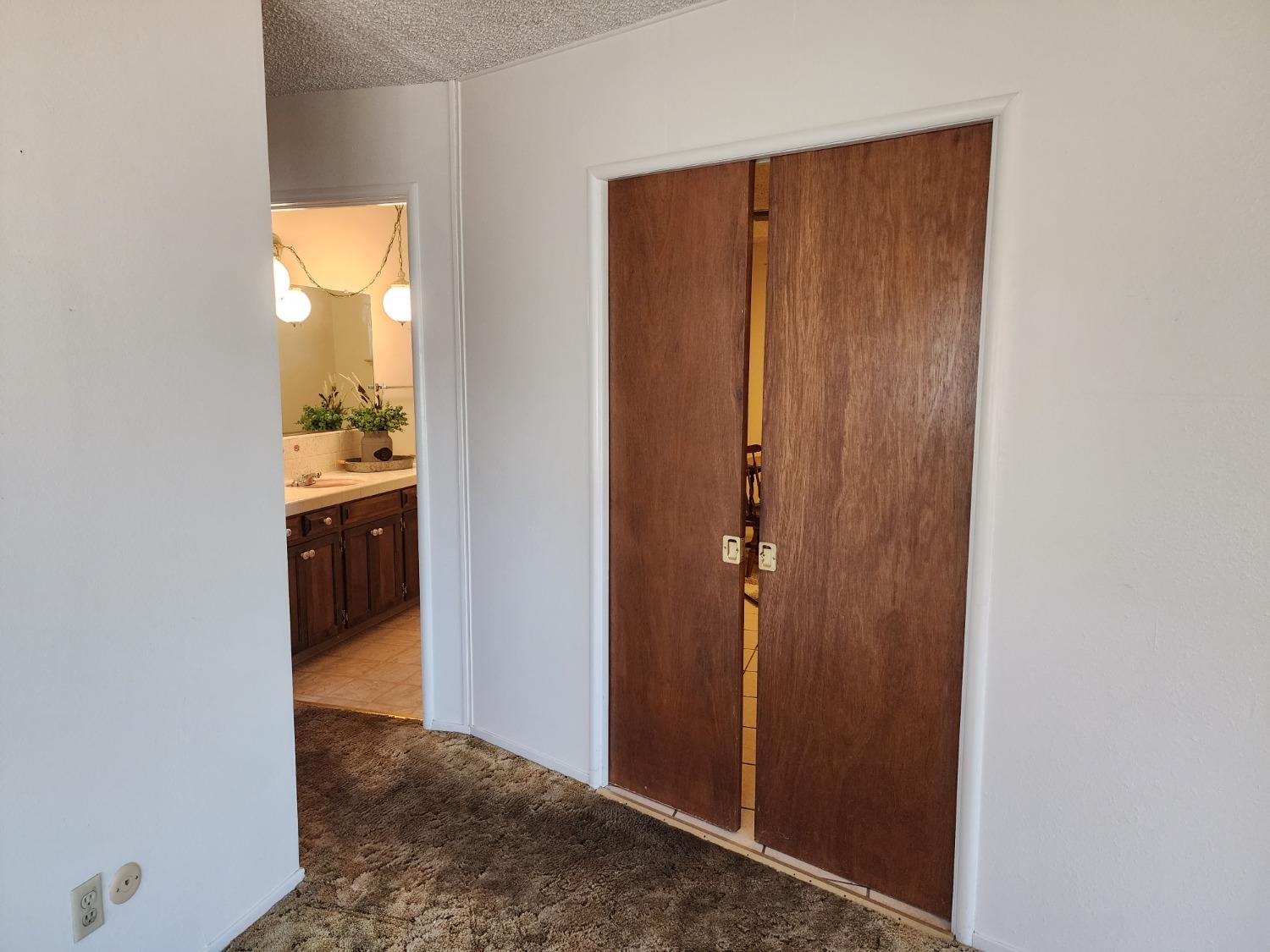 3653 Wright Street Selma, CA 93662 - Photo 23 of 41 a view of a hallway with a window and a kitchen