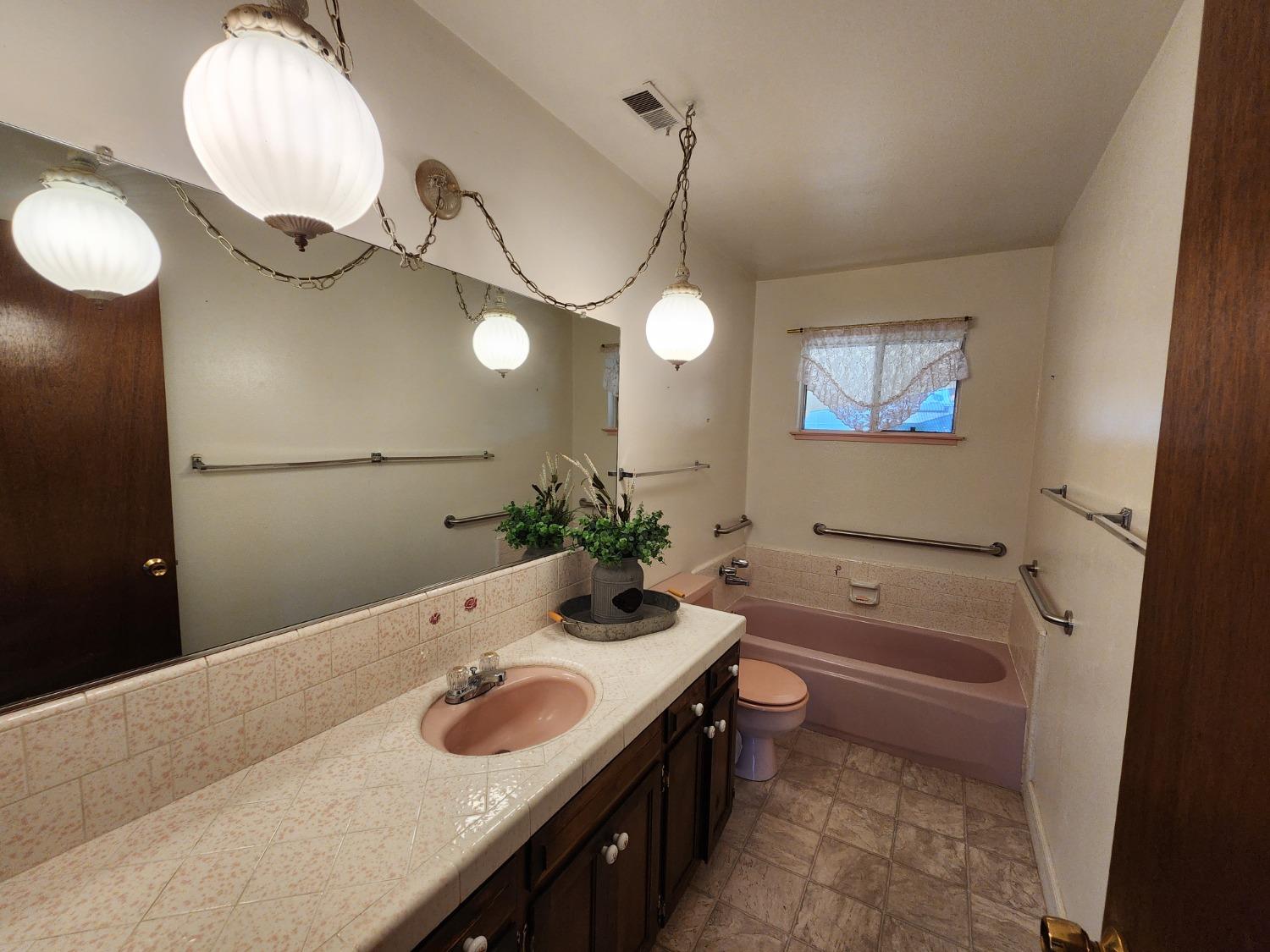 3653 Wright Street Selma, CA 93662 - Photo 27 of 41 a bathroom with a sink a tub and a mirror